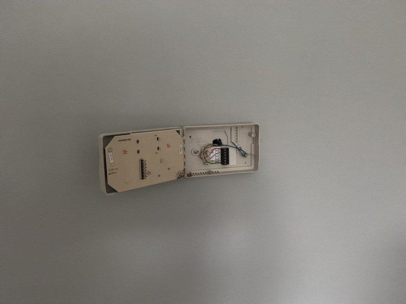 Provided estimate for complete zone system replacement including thermostats after diagnosing nonfunctional zone control system causing restricted airflow and subsequent evaporator coil freezing. Documented existing wall-mounted thermostat units and zone control panel with exposed wiring connections for replacement specifications.