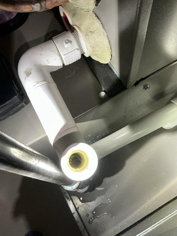 Responded to callback for furnace water leak and noisy blower motor on 2.5-year-old forced air unit. Upon inspection, discovered condensate drain line issue with PVC discharge pipe showing improper pitch. Verified condensate drain system, checked trap assembly, and confirmed proper drainage flow. Leveled and adjusted condensate line routing to ensure gravity drainage and prevent future water accumulation. Inspected blower assembly for noise concern - unit operating within normal parameters at time of visit. Documented installation with level measurements and photographed condensate piping configuration for records. System tested and confirmed heating operation with no active water leakage observed during service call.