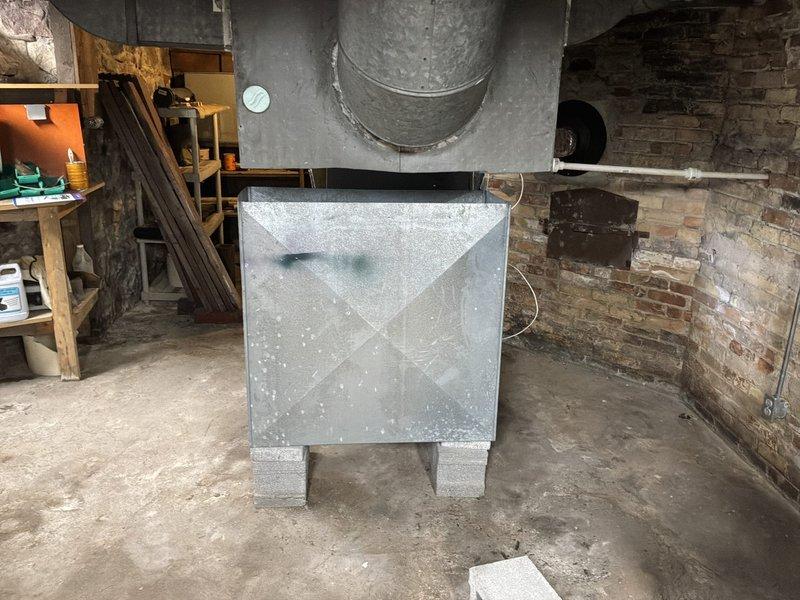Conducted estimate for furnace replacement on 20-year-old existing unit located in basement utility room. Assessed current system condition, noting aged equipment with moisture accumulation on ductwork and metal components. Evaluated installation space, existing ductwork configuration, wooden framing structure, and accessibility for replacement work. Documented equipment specifications, venting requirements, and electrical connections. Provided homeowner with comprehensive replacement options and recommendations based on current system layout and mechanical room conditions.