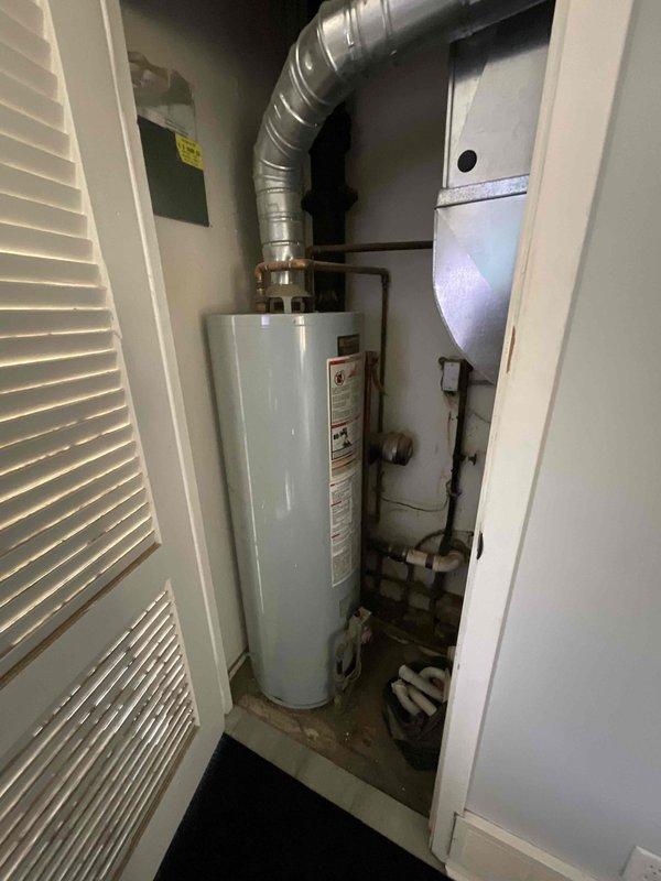 Conducted comprehensive site evaluation for air conditioning system installation at residential property currently without cooling equipment. Assessed main floor utility closet housing existing natural gas furnace, water heater, and ductwork configuration to determine optimal placement and integration requirements for new AC system. Documented existing HVAC infrastructure including vertical duct runs, elbow configurations, and confined space constraints, and evaluated vent stack considerations for proper system design and equipment compatibility.