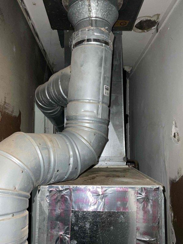Conducted comprehensive site evaluation for air conditioning system installation at residential property currently without cooling equipment. Assessed main floor utility closet housing existing natural gas furnace, water heater, and ductwork configuration to determine optimal placement and integration requirements for new AC system. Documented existing HVAC infrastructure including vertical duct runs, elbow configurations, and confined space constraints, and evaluated vent stack considerations for proper system design and equipment compatibility.