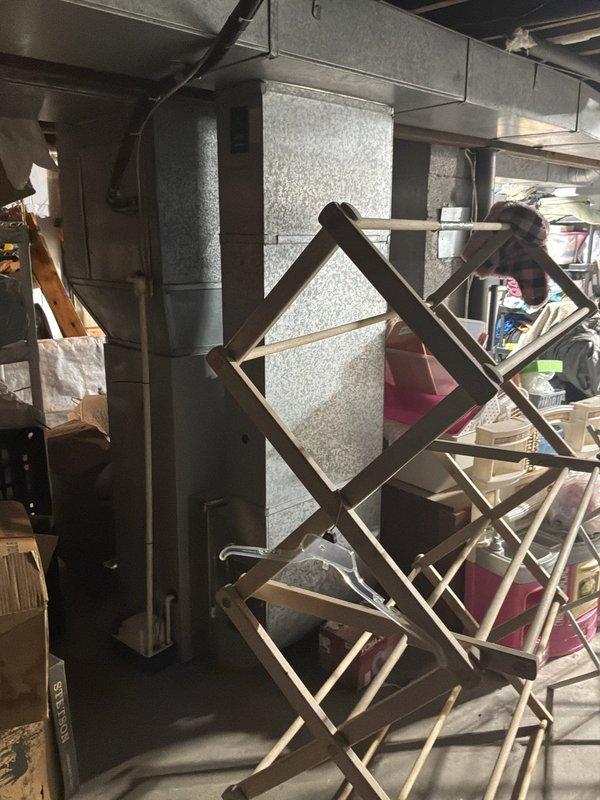 Conducted full system estimate for complete HVAC replacement at residential property with failed air conditioning unit and 31-year-old furnace requiring immediate replacement within the next couple weeks. Inspected existing equipment in basement utility area, photographed current ductwork configuration and plumbing infrastructure to assess compatibility with new system installation, and evaluated structural conditions including exposed floor joists and concrete foundation to determine optimal equipment placement and any necessary modifications for modern high-efficiency heating and cooling system.