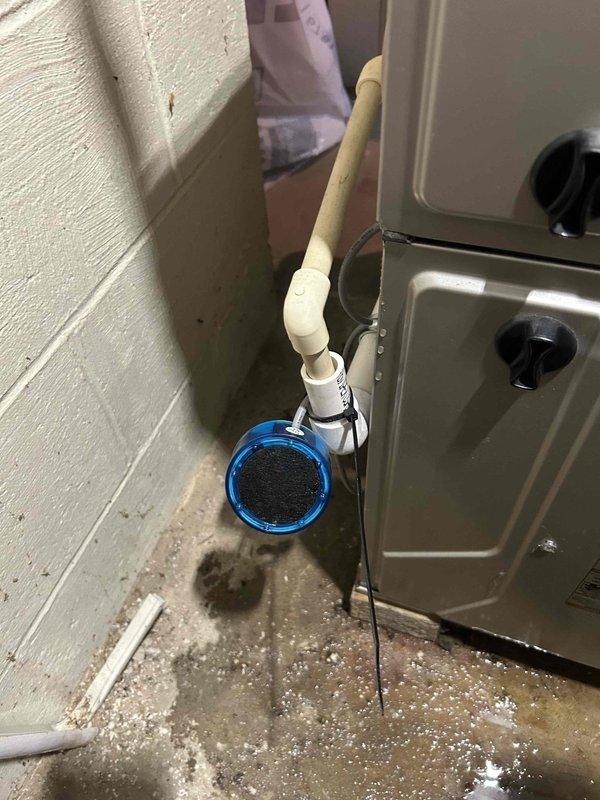 Responded to service call for air conditioning system not cooling due to water leak from cracked condensate leak detector. Upon inspection, found the condensate pump assembly experiencing leakage at the detector connection, causing water damage to surrounding floor area and preventing proper system operation. Replaced faulty leak detector component and condensate pump assembly, reconnected drainage lines with proper PVC fittings, tested system for proper drainage flow, and verified air conditioning unit returned to normal cooling operation with no further leakage detected.