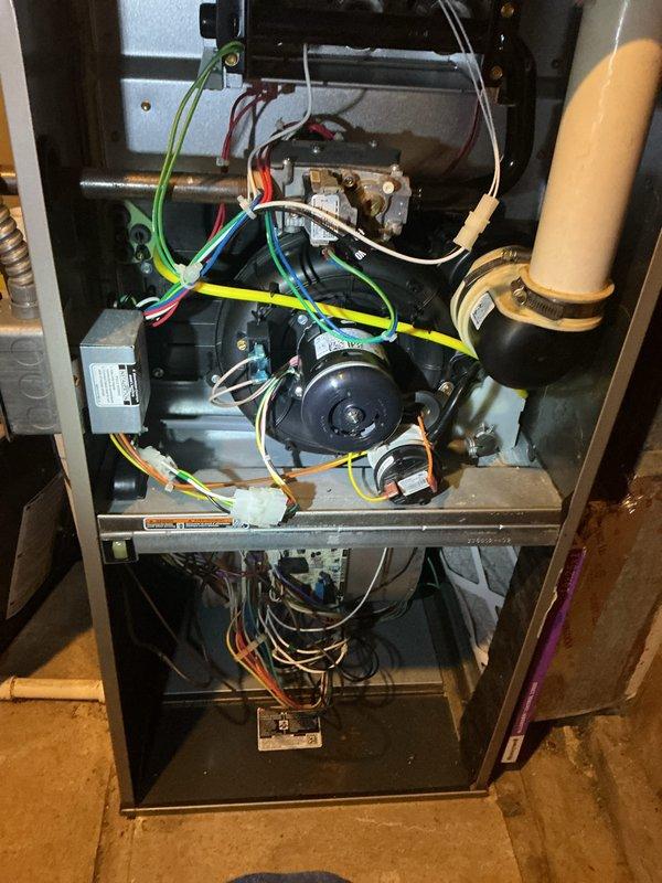 Completed annual heating maintenance on residential forced-air furnace system. Performed comprehensive inspection of all major components including gas valve assembly, blower motor, electrical connections, and control wiring. Verified thermostat operation and confirmed system holding temperature at 70°F with proper humidity reading of 66%. Inspected interior furnace cabinet, checked all wire connections across multiple circuits, and examined condensate drain line routing. All components found operating within normal parameters with no immediate service needs identified.