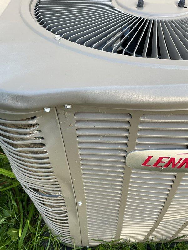 Completed comprehensive annual cooling maintenance on Lennox air conditioning system under Air Care membership agreement. Performed full AC tune-up including inspection of outdoor condenser unit, verification of fan operation and blade condition, examination of exterior housing and ventilation louvers, and assessment of overall system condition. Unit found in operational condition with minor debris accumulation noted in ventilation slats; cleaned as needed to ensure proper airflow. All components functioning within normal parameters with no immediate service concerns identified.