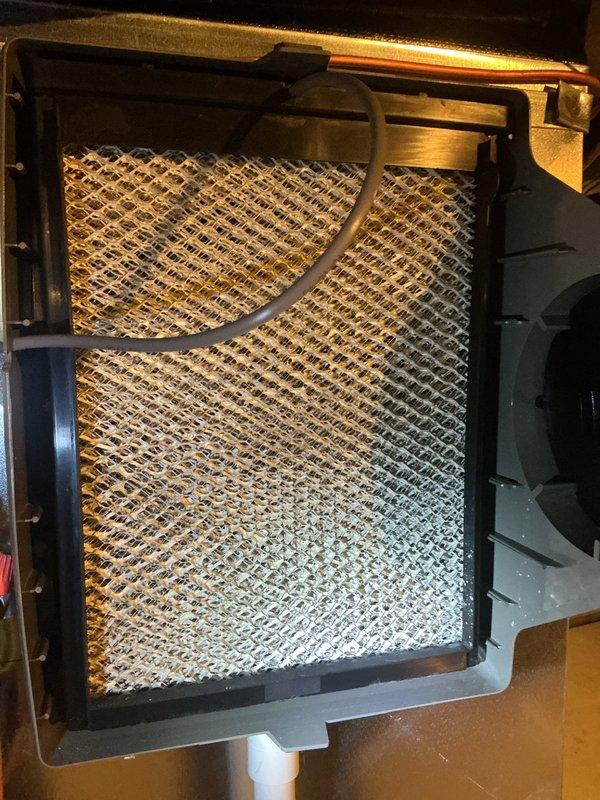 Completed ComfortGuard Maintenance package including filter and evaporative cooler pad replacement. Verified thermostat operation showing proper display function at 78°F setpoint. Removed and replaced dirty expanded metal mesh filter from evaporative cooler media tray, which showed moderate dust accumulation and discoloration from use.
