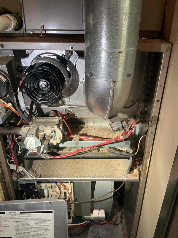 Responded to no-heat call on forced air furnace system. Upon arrival, performed visual inspection of furnace cabinet and components. Utilized Milwaukee inspection camera to examine interior ductwork and heat exchanger for obstructions, cracks, or deterioration. Camera inspection revealed accessible areas of duct system and internal components appeared intact with no visible damage to heat exchanger surfaces.

Removed furnace access panel to conduct thorough assessment of blower motor assembly, electrical connections, burner assembly, and control board. Inspected blower motor housing and fan blades for proper operation. Examined all visible electrical wiring, including red and black power leads from motor assembly, for signs of damage, loose connections, or deterioration. Verified routing and securing of electrical conduits throughout system.

Evaluated heat exchanger and burner assembly components, noting dust accumulation on surfaces consistent with normal operational wear. Checked co