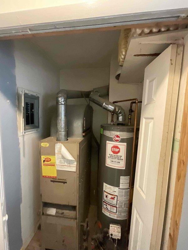 Provided replacement estimate for 30+ year old natural gas forced air furnace located in utility room off kitchen. Current unit operational but customer seeking proactive replacement for reliability during winter months. Evaluated existing installation including ductwork configuration, electrical service panel, and utility closet space constraints to determine appropriate replacement options focused on dependable mid-range equipment suitable for residential heating needs.
