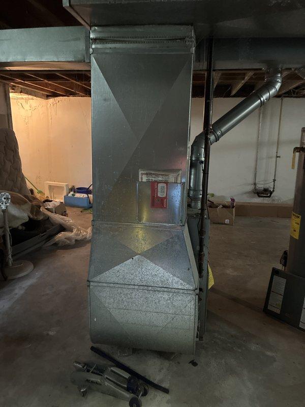 Completed full system estimate for residential property requiring replacement of 22-year-old furnace from 2004 and installation of new air conditioning unit under promotional package. Assessed existing basement HVAC infrastructure including ductwork configuration, electrical service capacity, and available space for new equipment installation. Documented current furnace condition and absence of air conditioning system, photographed existing equipment and installation area, and provided comprehensive proposal for complete heating and cooling system replacement.