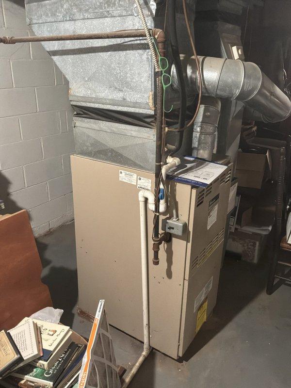 Provided comprehensive estimate for complete HVAC system replacement including both furnace and air conditioning units. Existing 27-year-old air conditioning system non-operational and beyond serviceable life expectancy. Documented current basement furnace installation and exterior condenser unit condition through photographic assessment to support replacement recommendations for matched heating and cooling system.
