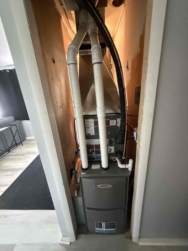 Completed full HVAC system installation including 45,000 BTU furnace, 1.5 ton air conditioning unit with evaporator coil, and 40-gallon water heater (model RG1PV40S6N). Installed new electrical circuit to support equipment. Ran white PVC intake and exhaust venting through exterior wall for high-efficiency furnace operation. Mounted Lennox furnace unit in utility closet with proper clearances and secured all ductwork connections. Completed mechanical and electrical permit applications for furnace, AC, and water heater installations. All equipment tested and operational upon completion.