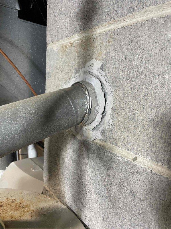 Conducted water heater estimate at single-family residence with non-functional existing unit requiring urgent replacement. Assessed current Bradford White Defender Safety System water heater installation, documented unit dimensions and existing plumbing configuration including copper supply lines with brass fittings, galvanized flue venting system, and PVC exhaust penetration through concrete block foundation wall. Provided replacement options and installation specifications for expedited service.