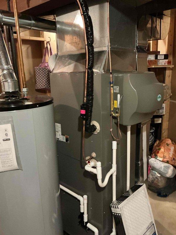 Responded to no cooling complaint on 1-year-old residential AC system with history of recent refrigerant leak repair. Upon arrival, performed comprehensive system evaluation including indoor air handler in basement and outdoor condensing unit. Conducted refrigerant pressure testing and leak detection procedures to identify source of recurring issue. Found evidence of refrigerant loss consistent with previous service history. Performed electronic leak detection on all refrigerant circuit components including evaporator coil, condensing unit, line set connections, and service ports. Located active leak at refrigerant connection point. Recovered remaining refrigerant from system per EPA regulations. Repaired leak, evacuated system to proper vacuum levels, and recharged unit to manufacturer specifications. Verified proper system operation with temperature split readings and confirmed adequate cooling performance. System restored to normal operation with cold air delivery confirmed at suppl