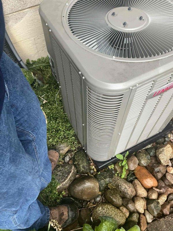 Completed air conditioning maintenance and tune-up on residential split system outdoor condenser unit. System had previously received furnace maintenance; this visit focused on the cooling equipment inspection and seasonal preparation. Performed comprehensive evaluation of condenser unit including visual inspection, cleaning of debris from surrounding area, assessment of coil condition, and verification of proper operation. Unit found to be functioning properly with no issues identified. Documented equipment condition with photographs showing outdoor condenser placement on protective pad with some accumulated debris and dirt on exterior panels, consistent with normal outdoor exposure for a system approximately two years old.