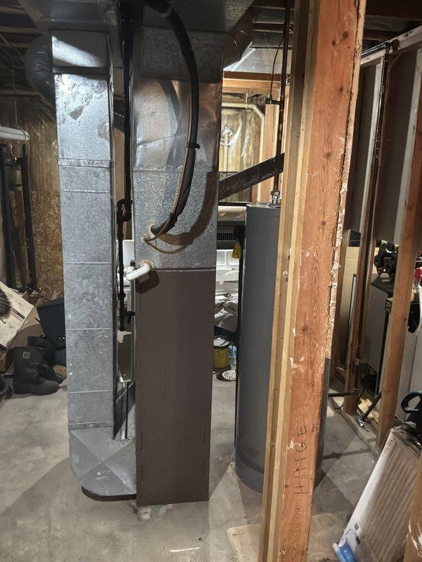 Conducted comprehensive estimate for complete HVAC system replacement at owner-occupied residence. Evaluated existing 25-year-old furnace and air conditioning system, both units having reached end of serviceable life expectancy. Assessed outdoor condensing unit positioned on concrete pad against exterior wall with PVC condensate line and electrical disconnect, noting age-related wear consistent with quarter-century operation. Inspected indoor furnace/air handler located in unfinished basement area with existing ductwork configuration and supply plenum connections. Documented current system specifications, equipment placement, electrical service requirements, and ductwork layout through photographic documentation. Provided detailed replacement options for matched heating and cooling system under buy-one-get-one promotional program, including equipment specifications, efficiency ratings, installation scope, and warranty coverage for homeowner consideration.