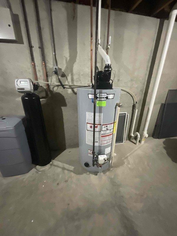 Conducted comprehensive site evaluation for new whole home generator installation at manufactured home residence. Assessed existing electrical service panel, main meter configuration, and available utility connections to determine optimal generator placement and integration requirements. Documented current electrical infrastructure including exterior meter mounting, disconnect box location, and interior utility room layout with water heater and treatment systems to identify proper transfer switch positioning and fuel line routing for Kohler generator system installation.