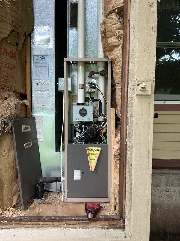 Completed annual HVAC maintenance on two air handling systems. Inspected furnace unit in basement mechanical room, verifying proper operation of all components, electrical connections, and ductwork integrity. Serviced exterior HVAC equipment panel with Energy Pro controls, checking electrical panel connections, conduit routing, and system wiring during ongoing construction phase with exposed wall framing.