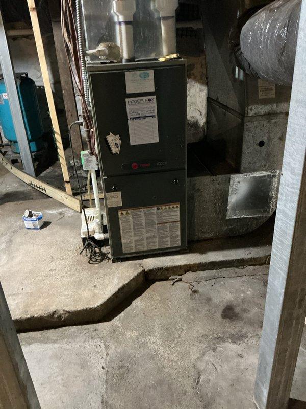Completed annual HVAC maintenance on two air handling systems. Inspected furnace unit in basement mechanical room, verifying proper operation of all components, electrical connections, and ductwork integrity. Serviced exterior HVAC equipment panel with Energy Pro controls, checking electrical panel connections, conduit routing, and system wiring during ongoing construction phase with exposed wall framing.