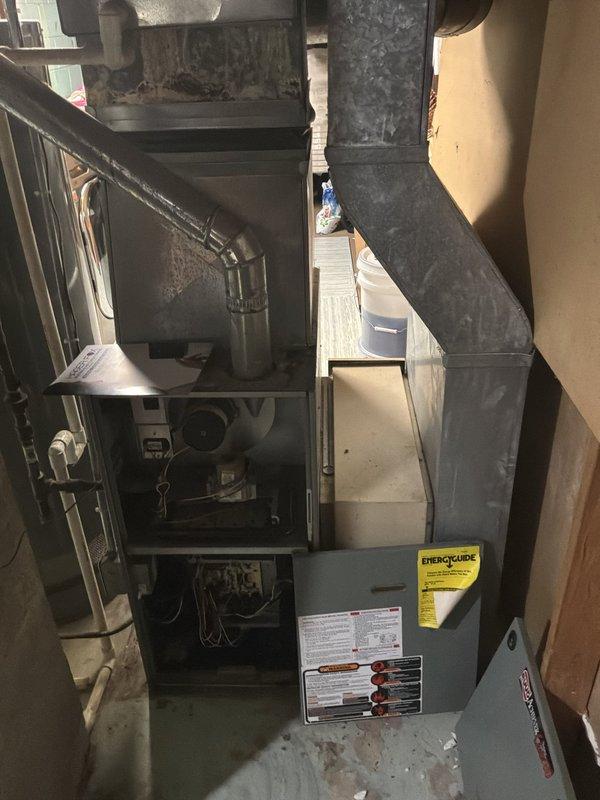 Conducted comprehensive HVAC system evaluation for basement-located equipment in ranch-style residence. Assessed existing non-operational furnace and air conditioning system for complete replacement options. Documented current installation configuration including natural gas furnace, ductwork layout, and associated mechanical components. Provided replacement estimates for both air conditioning unit only and complete furnace and air conditioning system package to address failed equipment.