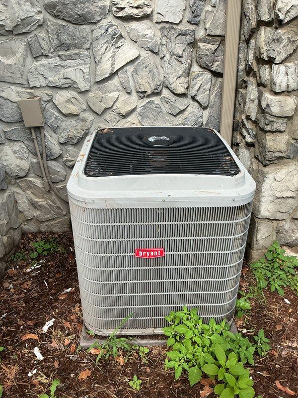 # Annual AC Tune-Up Completed

Performed comprehensive annual maintenance on a 10-year-old Bryant outdoor condensing unit. System was operating properly upon arrival. Completed full tune-up protocol including inspection of all major components, refrigerant line connections, electrical connections, and condenser coil condition. Verified proper fan operation and checked protective grille assembly. Unit exterior showed normal weathering for age. Noted vegetation growth around base of unit on concrete pad—recommended periodic clearing to maintain adequate airflow clearance. All safety controls tested and functioning within normal parameters. System left in optimal operating condition for cooling season.