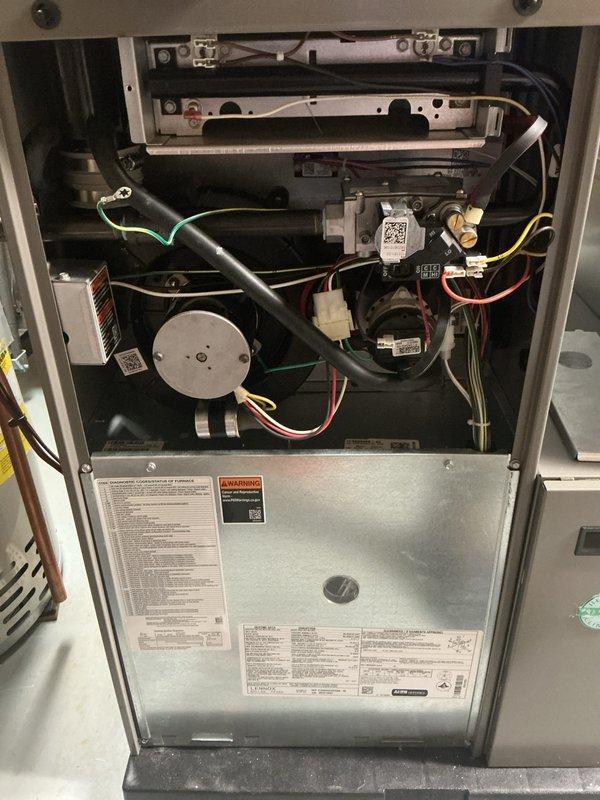 Completed comprehensive maintenance service on a 3-year-old forced air furnace and air conditioning system. Performed full inspection of furnace interior components including blower motor assembly, inducer fan, gas valve assemblies, electronic control modules, and burner compartment. Verified all electrical connections, wiring harnesses, and safety controls functioning properly. Inspected combustion chamber and heat exchanger for proper operation. Conducted AC tune-up including system performance evaluation. Verified thermostat operation and calibration, confirming proper communication between control unit and HVAC equipment. All heating and cooling components tested and operating within manufacturer specifications with no deficiencies noted.