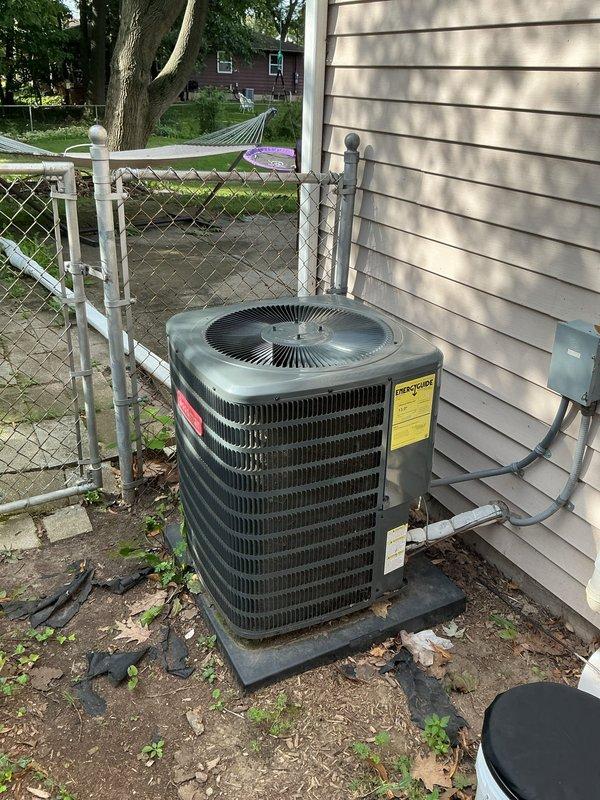 Responded to service call for air conditioning system providing insufficient cooling. Upon arrival, verified thermostat was set to 68°F with current indoor temperature reading 73°F, indicating a 5-degree temperature differential. Performed visual inspection of outdoor condenser unit located on exterior concrete pad. Unit appeared to be approximately 4 years old with no visible signs of physical damage or refrigerant leakage. Condenser coils showed normal wear consistent with age, and fan grille was intact and operational. Electrical connections and conduit appeared secure with no exposed wiring. System evaluated for potential issues affecting cooling capacity including airflow restrictions, refrigerant levels, and component functionality. Customer expressed interest in replacing furnace equipment located in basement. Documented current system conditions through photographic records of both thermostat display and outdoor condenser unit for reference.