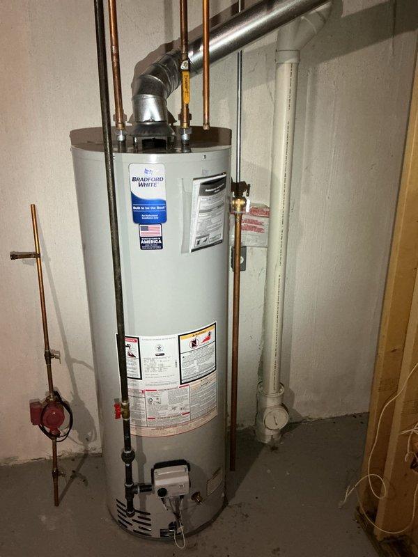 Responded to callback regarding extended hot water delivery time to kitchen, bathroom, and washer following recent 40-gallon natural draft water heater installation. Inspected Bradford White water heater installation, verified all copper supply lines, brass fittings, and connections were properly secured and functioning. Confirmed expansion tank installation and pressure relief system operational. Evaluated recirculation system with pump assembly on copper piping to address hot water wait times at fixtures throughout the residence.