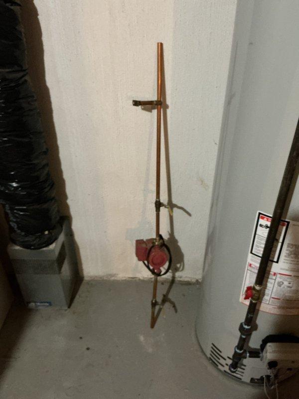 Responded to callback regarding extended hot water delivery time to kitchen, bathroom, and washer following recent 40-gallon natural draft water heater installation. Inspected Bradford White water heater installation, verified all copper supply lines, brass fittings, and connections were properly secured and functioning. Confirmed expansion tank installation and pressure relief system operational. Evaluated recirculation system with pump assembly on copper piping to address hot water wait times at fixtures throughout the residence.