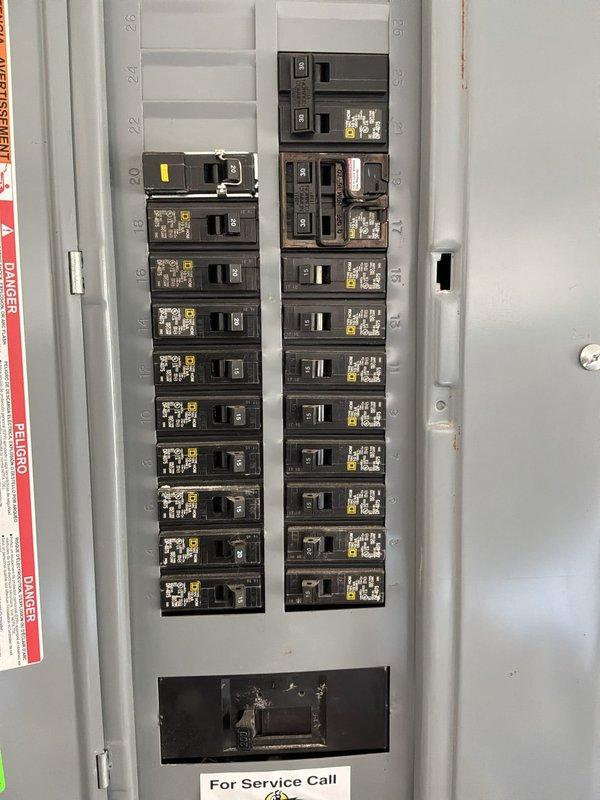 Conducted electrical estimate for new whole home generator installation at manufactured residence. Evaluated existing electrical panel configuration, which contains dual columns of circuit breakers with main breaker positioned at top right, numbered circuits 1-41, and adequate capacity for generator integration. Assessed kitchen area and overall electrical load requirements to determine proper generator sizing and transfer switch specifications for seamless backup power integration with current electrical system.