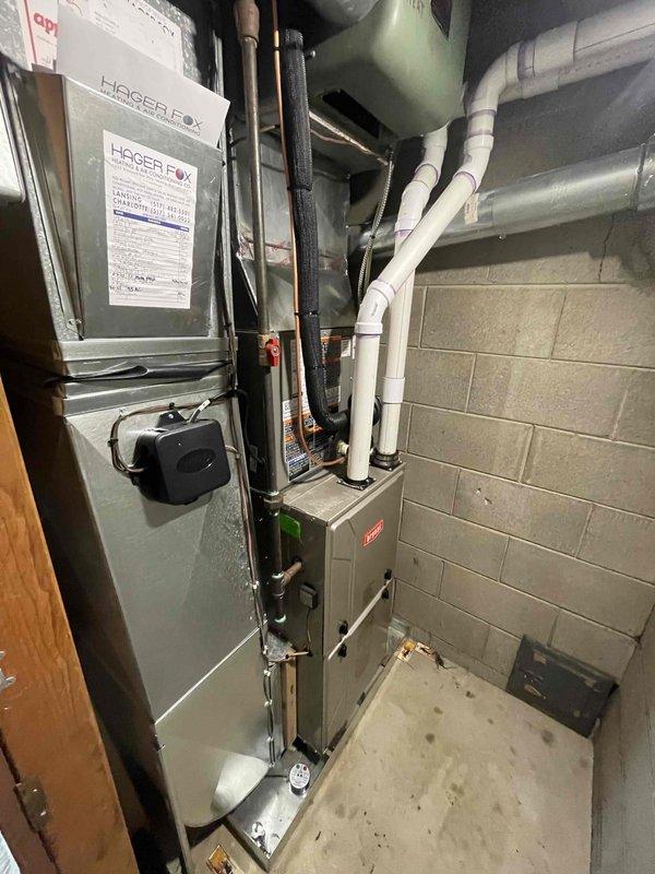 Completed mechanical-only installation of a 2-ton air conditioning system with evaporator coil on the right side of the residence. Installed new outdoor condenser unit on base pad against exterior wall with proper refrigerant line connections and electrical conduit routing. Mounted new evaporator coil with Bryant furnace system in basement mechanical room, connected all refrigerant lines with proper insulation, and installed necessary PVC condensate drainage piping. Reconnected all electrical components and verified proper system operation upon completion.
