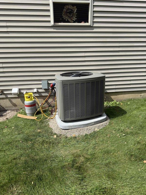 Completed full HVAC system installation including new furnace, air conditioning condenser unit, and evaporator coil. Installed outdoor condensing unit on concrete pad against exterior wall with proper refrigerant line connections. Mounted air handler vertically in basement utility area between wall studs with metallic flex duct and PVC condensate drain line properly routed. Charged system with refrigerant to manufacturer specifications using service gauges and recovery equipment. Verified all electrical connections, tested system operation in both heating and cooling modes, and confirmed proper airflow throughout. Installation performed in accordance with local building codes with permit documentation submitted for approval.