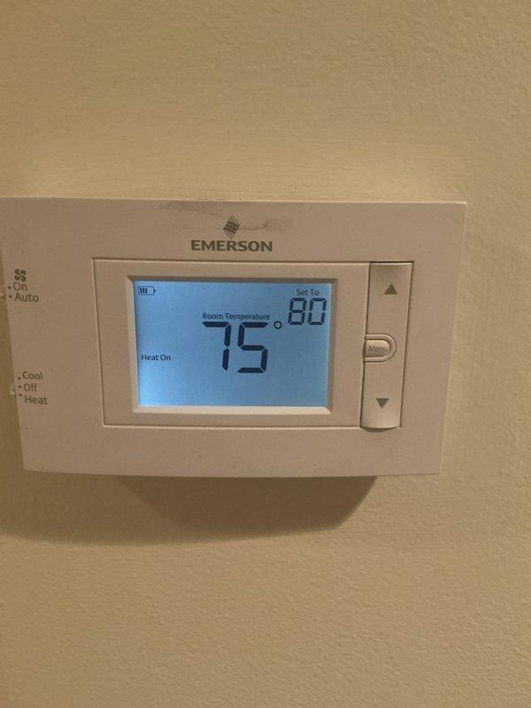 Completed annual heating and cooling maintenance service on residential HVAC system. Performed comprehensive system inspection, verified thermostat operation showing heat mode at 75°F room temperature with setpoint of 80°F, and replaced air filter with new pleated media filter to ensure proper airflow and system efficiency.