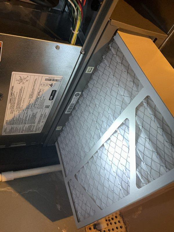 Completed comprehensive annual maintenance on a four-year-old furnace and air conditioning system under ComfortGuard Maintenance Package. Performed full AC tune-up including refrigerant level verification, condenser coil inspection and cleaning, electrical connection testing, and airflow measurements. Inspected air handler unit, verified proper filter installation, tested thermostat operation and calibration on ecobee digital control system, and confirmed all safety controls functioning within manufacturer specifications. Both heating and cooling systems operating efficiently with no deficiencies noted; all components passed inspection criteria.