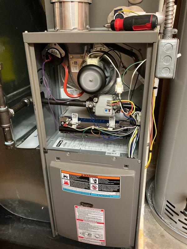 Completed comprehensive fall tune-up and maintenance on 2-year-old Lennox furnace system in preparation for heating season. System was operational upon arrival with Emerson digital thermostat reading 77°F with setpoint at 58°F and separate humidistat control functioning properly. Performed full inspection of furnace components including blower motor assembly, fan wheel, electrical connections, control boards, and wiring harness. Verified all safety labels and manufacturer specifications were intact and legible. System tested and confirmed to be operating within normal parameters and ready for winter heating demands.