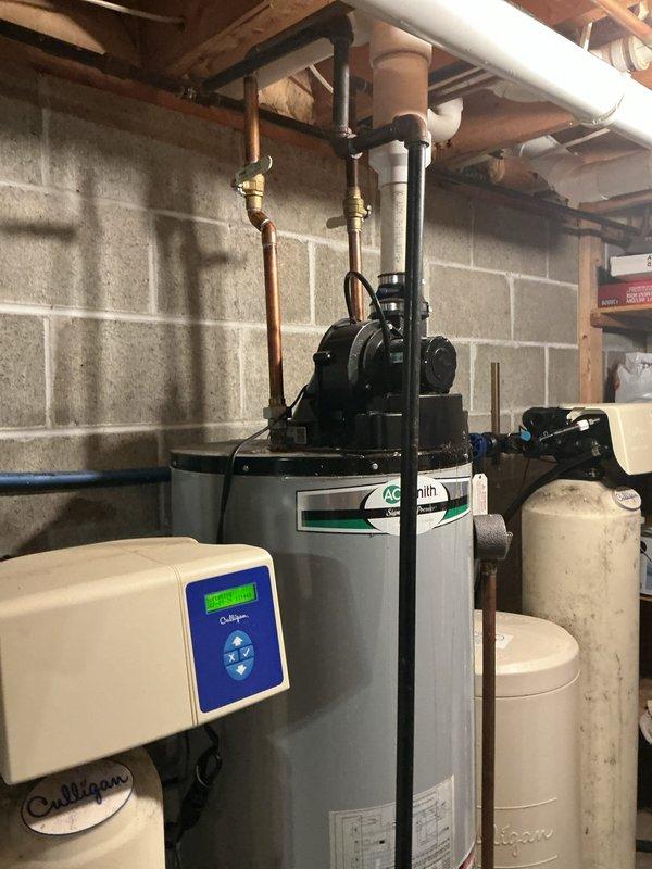 Responded to service call for A.O. Smith tanked water heater experiencing leaking at cold water intake nipples and gas valve fault signal resulting in no hot water production. Upon inspection, identified active water leakage at the cold water inlet connection causing moisture intrusion into the gas control valve system, triggering safety fault code. Assessed integrity of threaded pipe connections and determined intake nipple required resealing. Shut down gas supply and water feed to unit. Drained water heater tank to safe working level. Removed compromised cold water inlet nipple, cleaned threaded connections, applied appropriate thread sealant and Teflon tape, and reinstalled with proper torque specifications to manufacturer standards. Verified all connections for water-tight seal. Refilled tank, purged air from system, and restored gas supply. Reset gas control valve, relit pilot light, and verified burner ignition sequence. Monitored unit through complete heating cycle to confirm pr