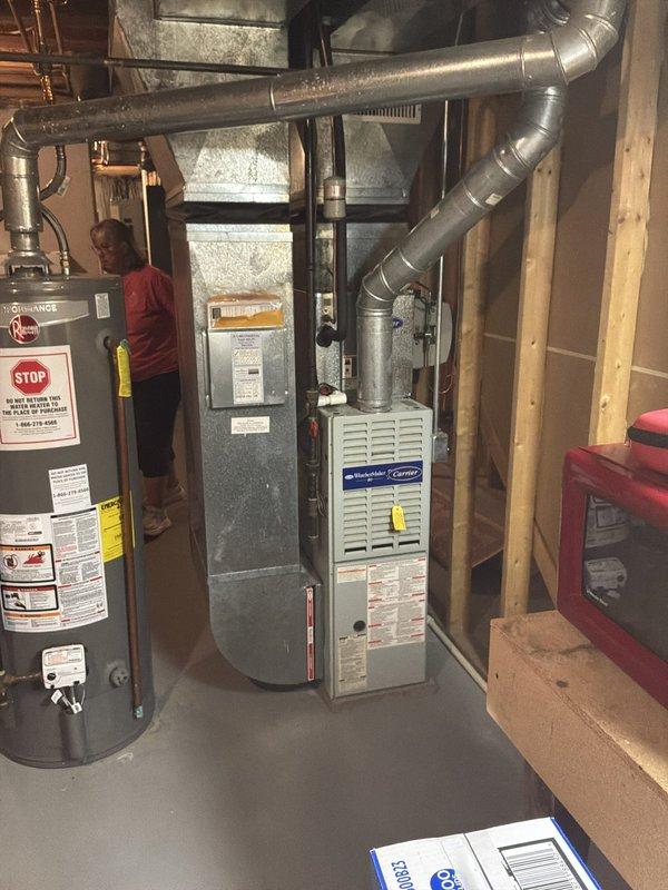 Provided comprehensive estimate for replacement of non-functioning 1997 Carrier furnace and air conditioning system located in basement mechanical room. Assessed existing HVAC equipment configuration, ductwork connections, and installation requirements for complete system replacement of 27-year-old heating and cooling units that have exceeded their service life.
