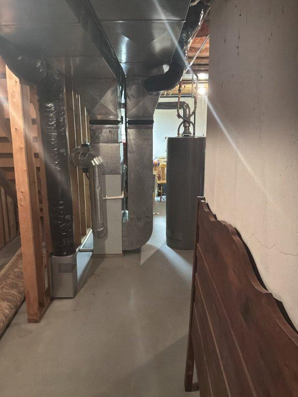 Provided comprehensive estimate for replacement of non-functioning 1997 Carrier furnace and air conditioning system located in basement mechanical room. Assessed existing HVAC equipment configuration, ductwork connections, and installation requirements for complete system replacement of 27-year-old heating and cooling units that have exceeded their service life.