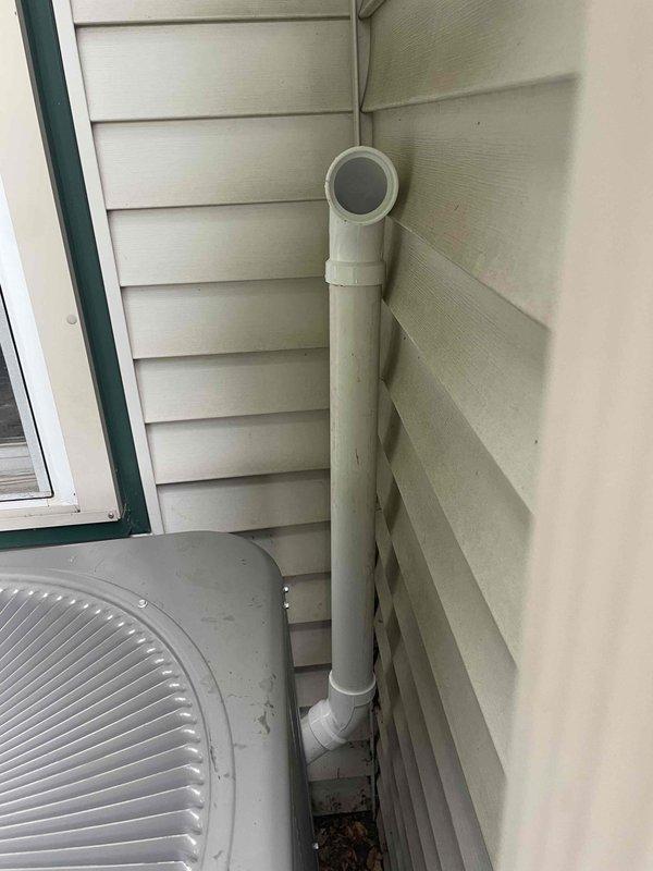 Completed full HVAC system installation including two furnaces (90,000 BTU and 45,000 BTU units), two air conditioning condensers (3-ton and 1.5-ton units), humidifier, and liner with all necessary reconnections. Both outdoor condenser units were positioned on concrete pads against the building exterior with proper drainage lines installed, and all refrigerant lines and electrical connections were completed per mechanical permit specifications.