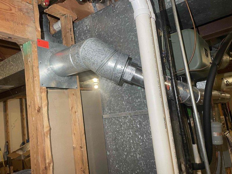 Conducted on-site assessment for non-functioning natural draft water heater replacement in residential property. Customer requested upgrade to 75-gallon capacity unit, requiring evaluation of existing installation space, venting configuration, and clearance requirements. Documented current equipment dimensions and surrounding utility infrastructure including ductwork, plumbing connections, and structural constraints to determine feasibility of larger capacity installation.