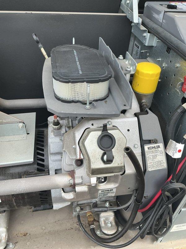Performed routine electrical maintenance on a 20kW Kohler standby generator system. Inspected air filter assembly, replaced oil filter, verified control panel operation and indicator lights, and confirmed all safety labels and warning systems were intact and functioning properly.