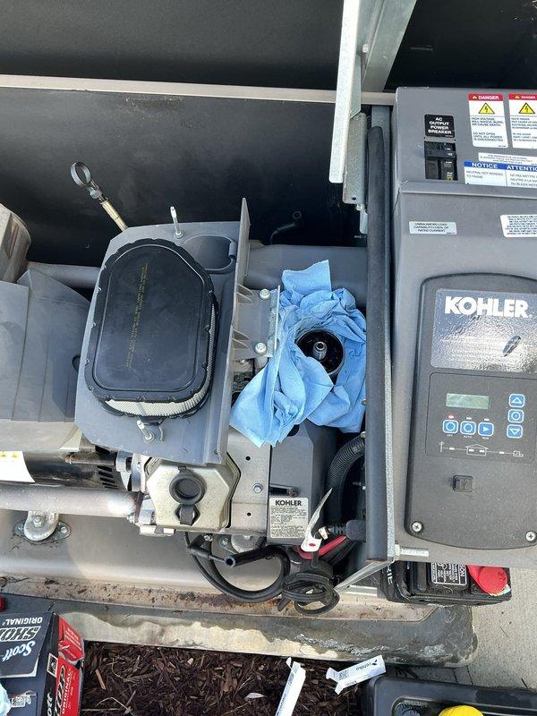 Performed routine electrical maintenance on a 20kW Kohler standby generator system. Inspected air filter assembly, replaced oil filter, verified control panel operation and indicator lights, and confirmed all safety labels and warning systems were intact and functioning properly.