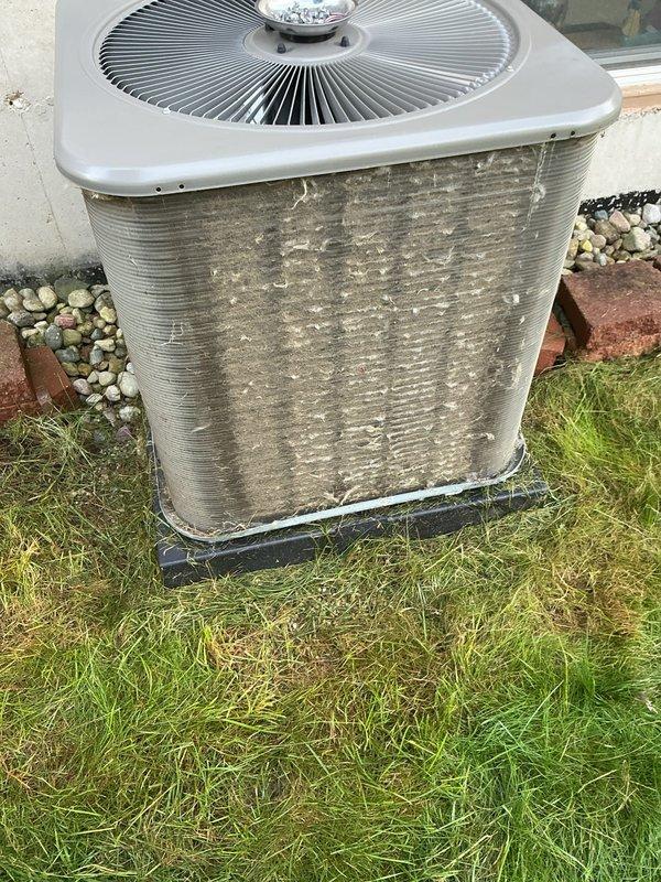 Completed comprehensive ComfortGuard maintenance service on residential HVAC system operating under 5-year warranty plan. Performed full tune-up on air conditioning condenser unit and furnace system, both confirmed in proper working condition. Outdoor condenser unit showed significant accumulation of dirt, dust, and debris on condenser fins and coils, which was thoroughly cleaned to restore optimal airflow and heat transfer efficiency. Inspected fan motor assembly, grille, and mounting pad for proper operation and stability. Verified refrigerant levels, electrical connections, and overall system performance. All components tested and functioning within normal parameters upon service completion.