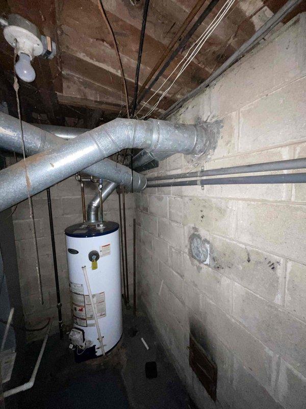 Provided estimate for complete replacement of 40+ year old non-operational furnace and air conditioning system located in basement. Current natural gas furnace and AC unit have exceeded their service life and require full system replacement. Assessment included evaluation of existing ductwork, electrical connections, gas line configuration, and ventilation requirements to determine proper equipment specifications and installation scope for new HVAC system.