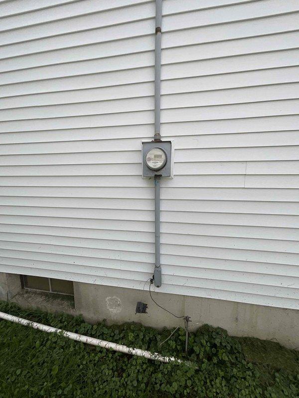 Completed full system estimate for residential HVAC replacement involving 16-year-old air conditioning unit and furnace located in basement utility area. Assessed existing white furnace with overhead ductwork distribution system and exterior condensing unit, documented current system configuration including electrical service connection at exterior meter location, and photographed equipment conditions to provide comprehensive replacement quote for complete heating and cooling system.