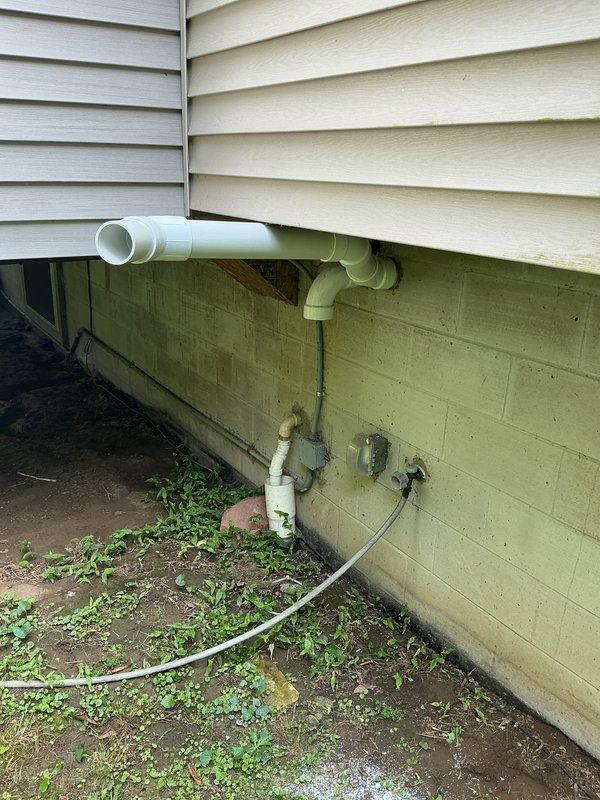 Responded to recall request to inspect exhaust pipe terminations on recently installed 90,000 BTU furnace and 3-ton air conditioning system. Verified proper installation and positioning of white PVC exhaust and intake pipes extending from foundation area, confirmed secure mounting and appropriate termination angles per manufacturer specifications. All combustion venting components found to be properly installed with no deficiencies noted; system operating within normal parameters.