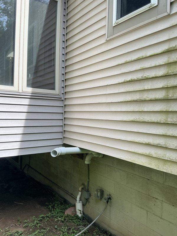 Responded to recall request to inspect exhaust pipe terminations on recently installed 90,000 BTU furnace and 3-ton air conditioning system. Verified proper installation and positioning of white PVC exhaust and intake pipes extending from foundation area, confirmed secure mounting and appropriate termination angles per manufacturer specifications. All combustion venting components found to be properly installed with no deficiencies noted; system operating within normal parameters.