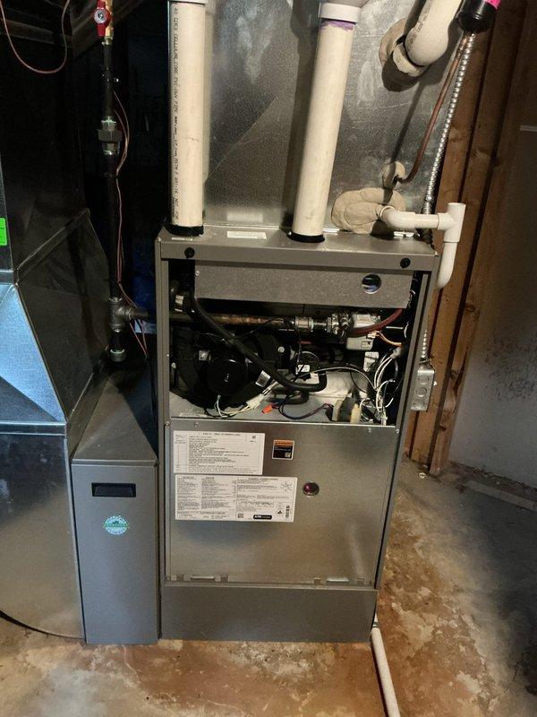 Completed comprehensive ComfortGuard Maintenance Package on 5-year-old forced air furnace and air conditioning system as part of ongoing five-year maintenance program following 2021 installation. Performed full AC tune-up including inspection of all mechanical components, refrigerant level verification, electrical connection testing, and condenser coil cleaning. Conducted furnace maintenance including burner inspection, heat exchanger examination, blower motor lubrication, air filter replacement, and safety control verification. Verified Sensi programmable thermostat operation and calibration at 72°F setpoint with proper heat and cool mode functionality. Inspected intake and exhaust PVC venting for proper clearance and secure connections. Tested system startup and shutdown sequences for both heating and cooling modes. All equipment operating within manufacturer specifications with no issues identified or repairs required.