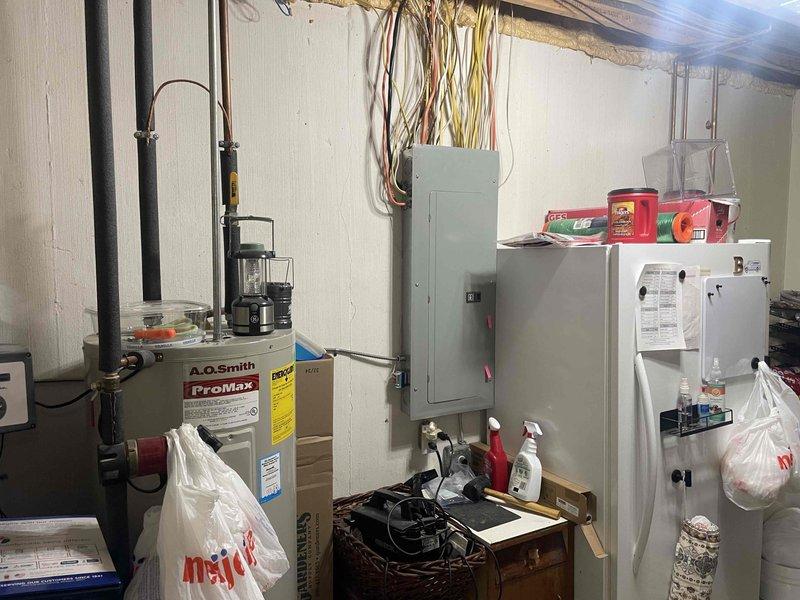 Conducted electrical estimate for whole home generator installation at manufactured home property. Assessed existing electrical panel capacity, service entrance configuration, and utility area layout in basement to determine generator sizing requirements and transfer switch placement. Documented current mechanical systems including water heater, HVAC equipment, and electrical infrastructure to prepare comprehensive installation proposal for Kohler whole home generator system.