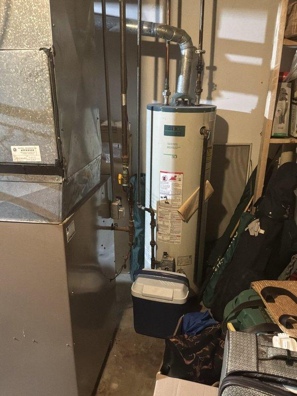 Conducted on-site assessment of existing basement-installed furnace and air conditioning system to provide replacement estimate. Evaluated current operational equipment, documented aging HVAC infrastructure including furnace unit with vertical ductwork configuration, and assessed electrical panel capacity for new system installation requirements.