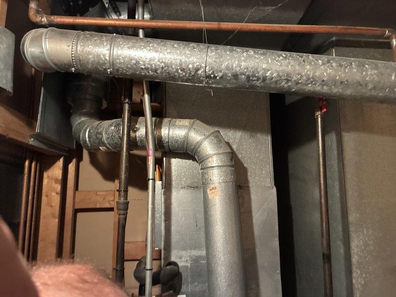Provided comprehensive estimate for complete HVAC system replacement including natural gas furnace and air conditioning unit located in basement. Existing 20+ year old equipment is non-operational with visible wear on internal components including blower motor, wiring, and control boards. Significant condensation observed on ductwork indicating potential efficiency and humidity control issues requiring attention during replacement installation.